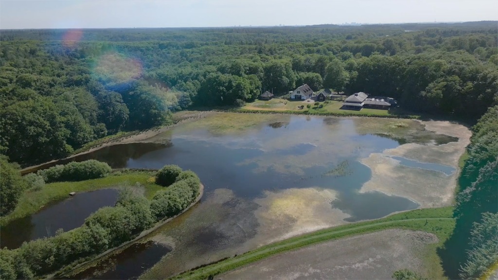 Aerial view of Retraitecentrum De Spil, lake and forests in Hilversum